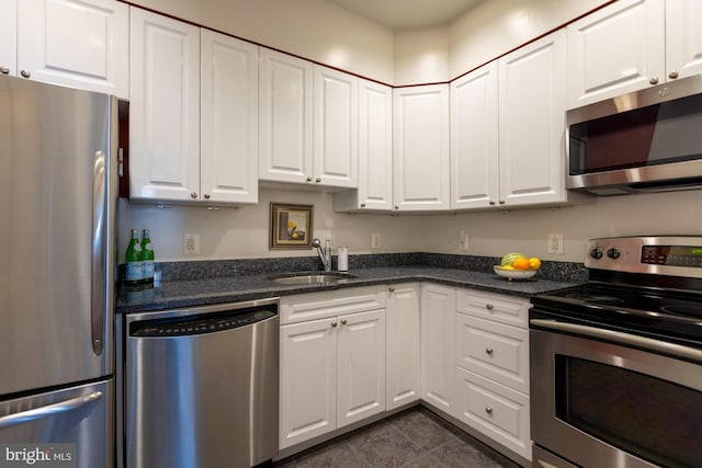 kitchen featuring white cabinets, appliances with stainless steel finishes, and sink