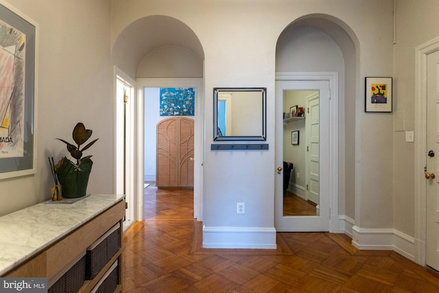 hall with dark parquet flooring