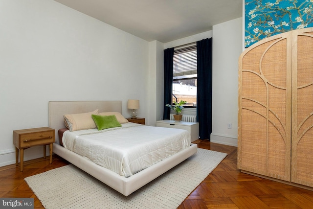 bedroom with dark parquet flooring