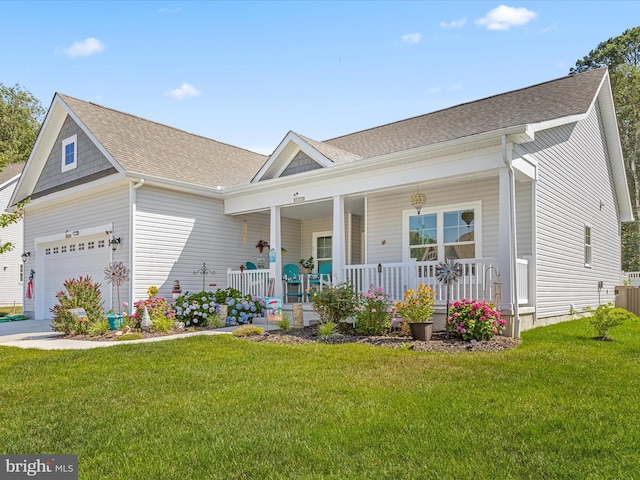 view of front of property featuring covered porch, concrete driveway, a shingled roof, and a front yard