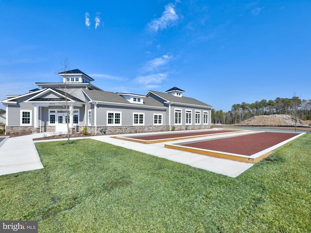 rear view of property featuring a lawn