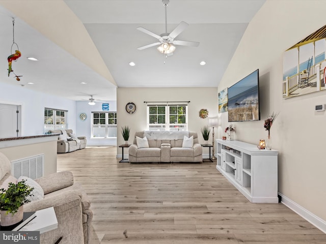 living room featuring light wood-type flooring, vaulted ceiling, and ceiling fan