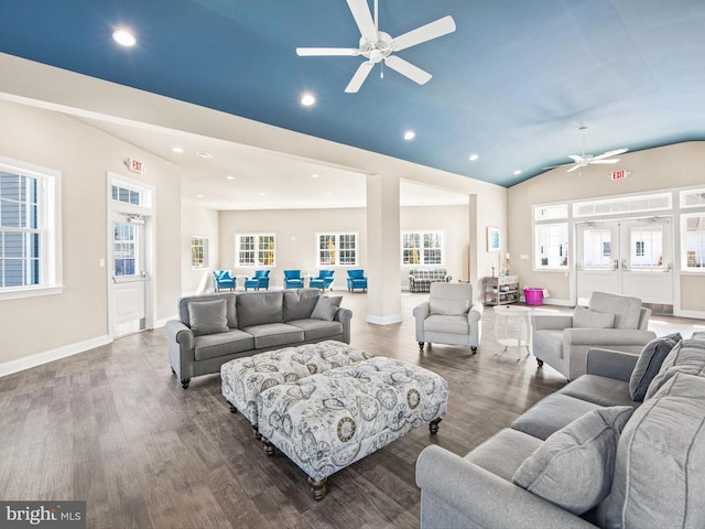 living room with ceiling fan, dark wood-type flooring, and vaulted ceiling