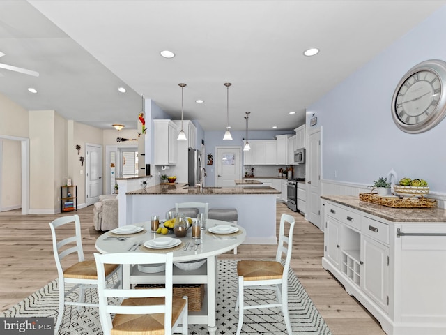 dining space featuring light hardwood / wood-style flooring and sink