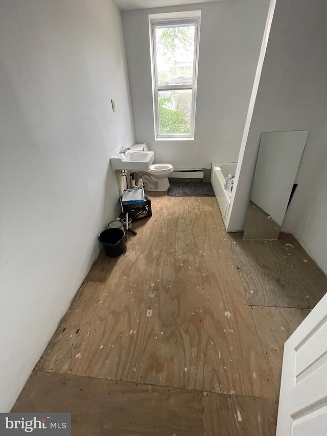 bathroom with a baseboard radiator, toilet, and sink