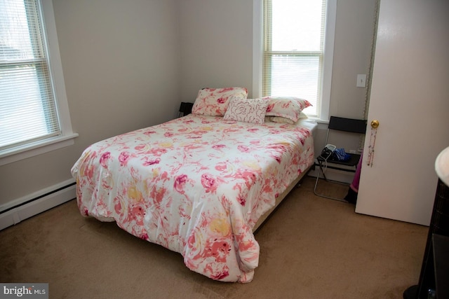 carpeted bedroom featuring a baseboard radiator and multiple windows