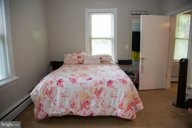 carpeted bedroom featuring a baseboard radiator