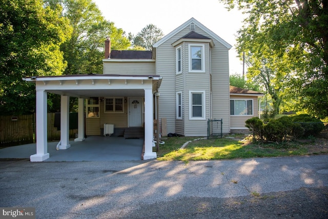 back of house with a carport