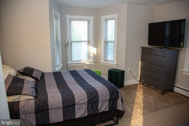 bedroom featuring carpet and a baseboard heating unit