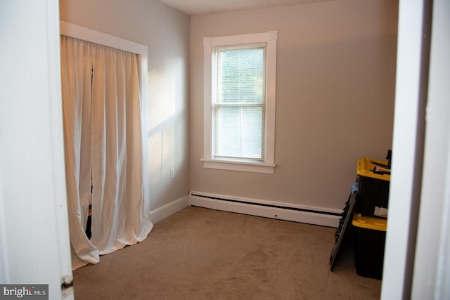 interior space featuring baseboard heating and carpet flooring