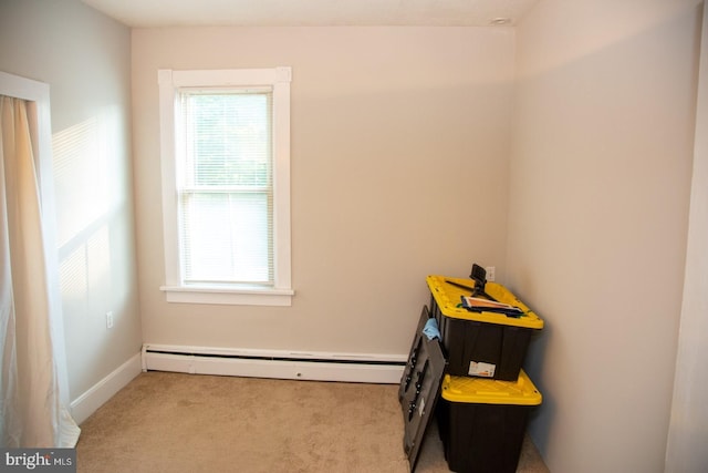 interior space featuring light carpet and a baseboard heating unit