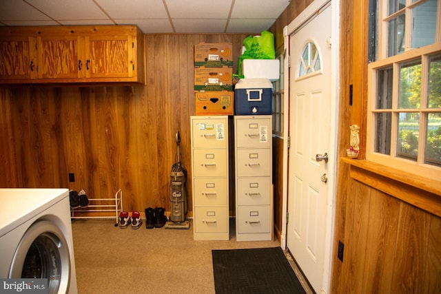 laundry room featuring wood walls, carpet, and washer / dryer