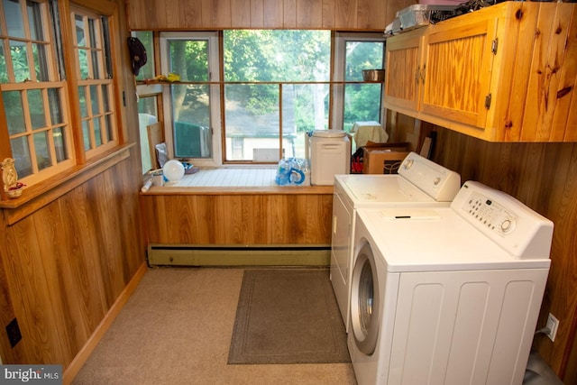 laundry room featuring cabinets, light carpet, a baseboard radiator, independent washer and dryer, and wood walls