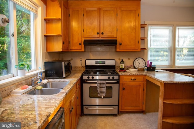 kitchen with sink, decorative backsplash, light tile patterned floors, light stone counters, and stainless steel appliances