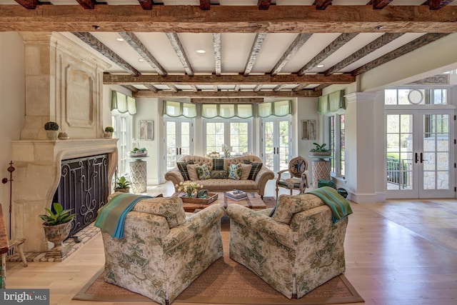 living room featuring beamed ceiling, french doors, and light wood-type flooring