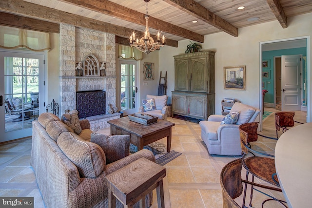 living room with a fireplace, an inviting chandelier, plenty of natural light, and wood ceiling