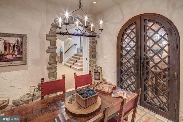 dining room with french doors and a notable chandelier