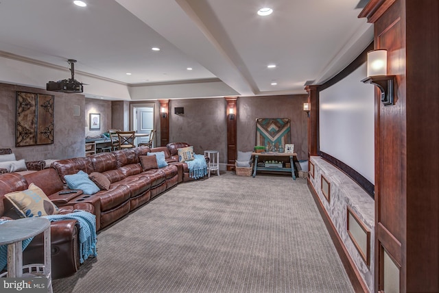 carpeted cinema room with ornate columns and crown molding