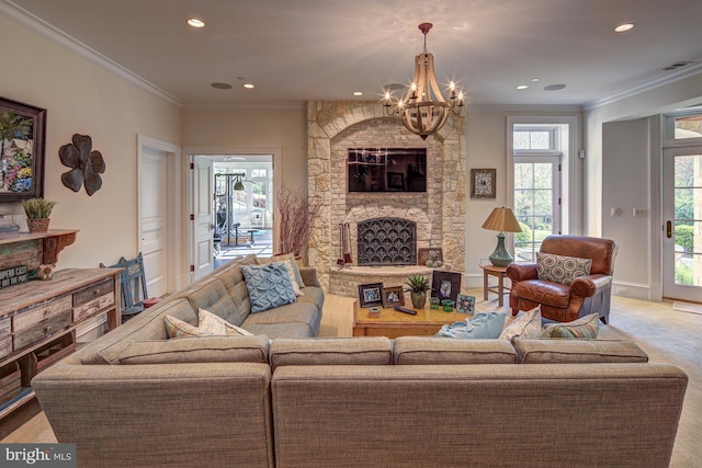 living room with an inviting chandelier, a stone fireplace, plenty of natural light, and crown molding