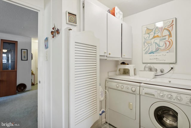 clothes washing area featuring washer and dryer, cabinets, carpet floors, and a textured ceiling