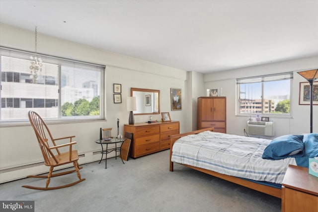 carpeted bedroom featuring an inviting chandelier, a wall mounted air conditioner, and a baseboard heating unit