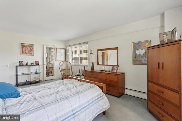 bedroom with light colored carpet and baseboard heating