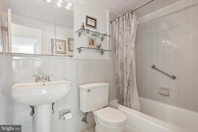 bathroom featuring shower / tub combo, tile walls, and toilet