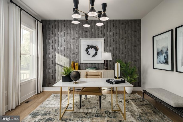 office featuring light hardwood / wood-style floors and a chandelier