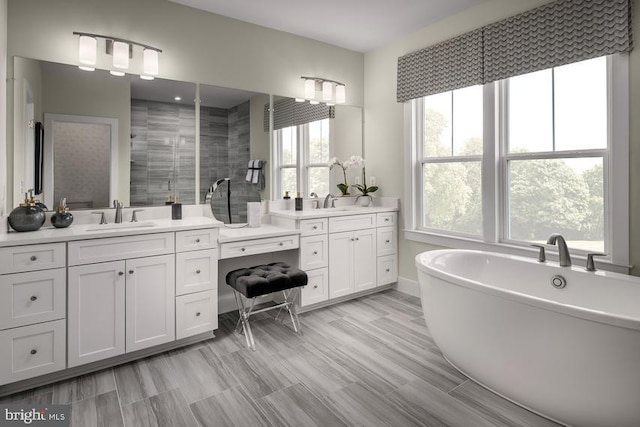 bathroom with vanity and independent shower and bath