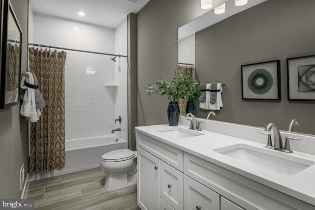 full bathroom with toilet, vanity, and shower / bath combination with curtain