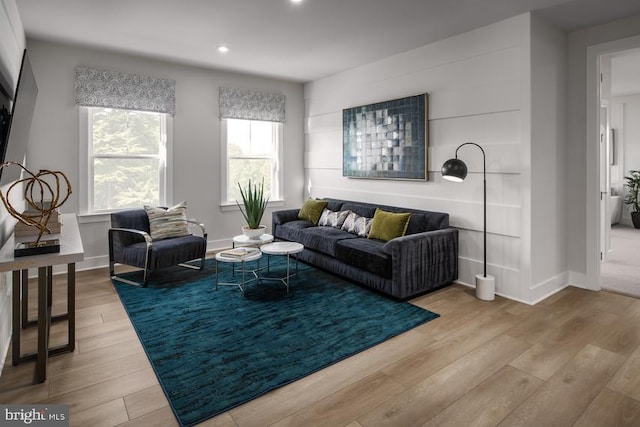 living room with a wealth of natural light and light hardwood / wood-style flooring