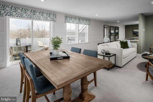 carpeted dining space featuring a healthy amount of sunlight