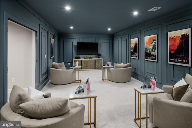 home theater room featuring light colored carpet