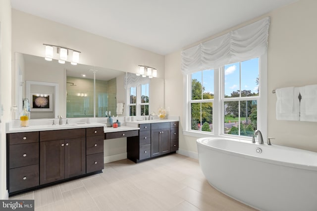 bathroom with independent shower and bath, tile patterned floors, and vanity