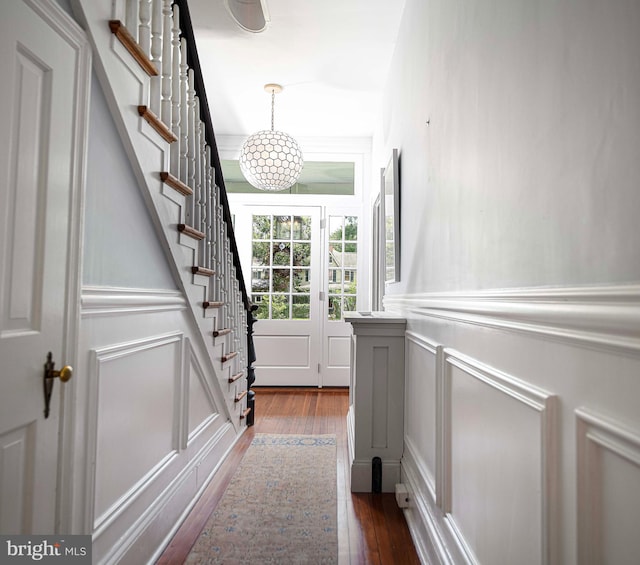 interior space with an inviting chandelier and hardwood / wood-style flooring