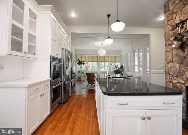 kitchen with white cabinetry, hanging light fixtures, and dark wood-type flooring