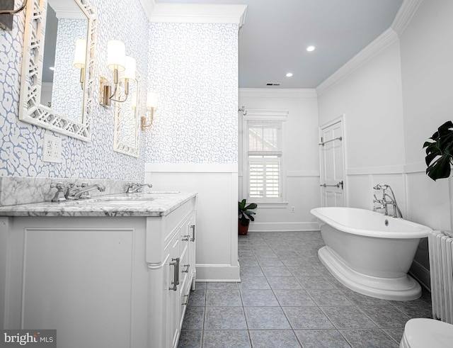 bathroom with a washtub, vanity, crown molding, and radiator