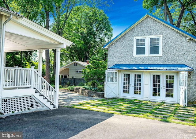 view of side of home featuring french doors