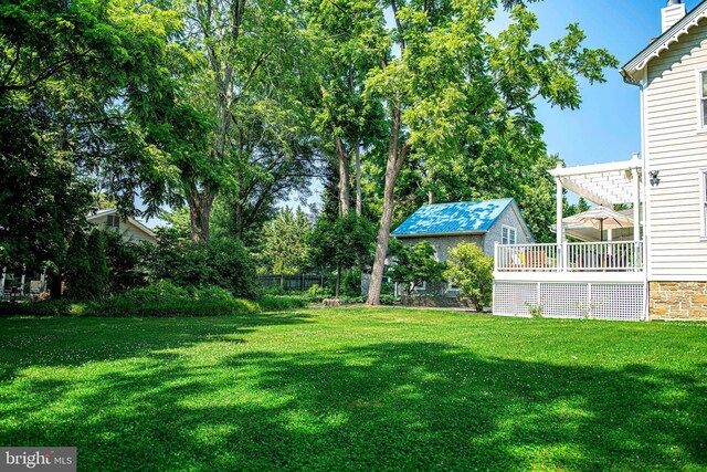 view of yard featuring a pergola and a deck