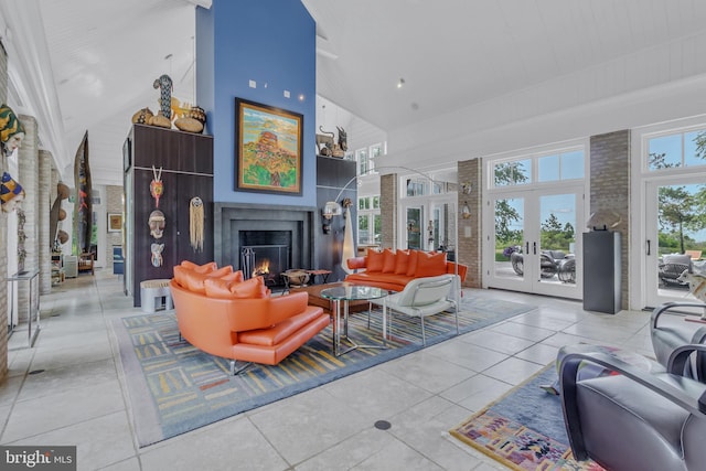 tiled living room with french doors and a high ceiling