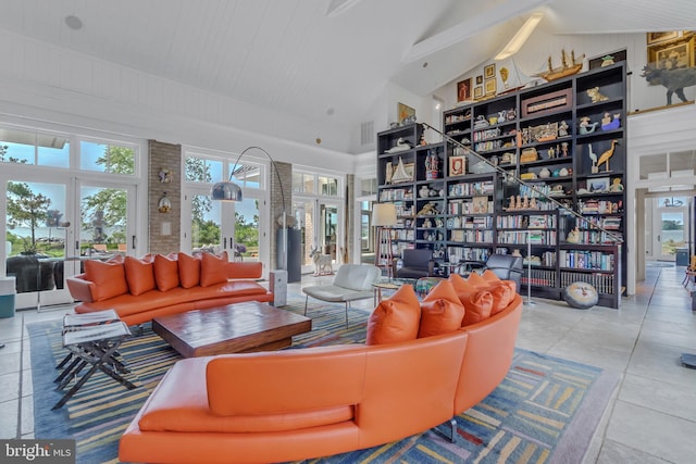 living room featuring beamed ceiling, tile patterned flooring, high vaulted ceiling, and french doors