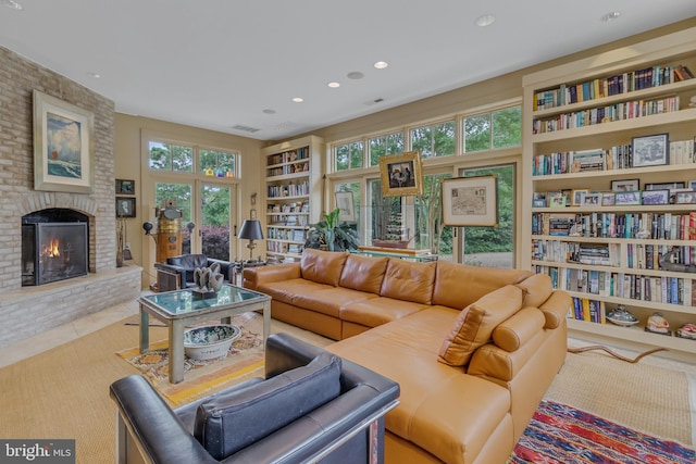 tiled living room with built in shelves, a wealth of natural light, and a fireplace