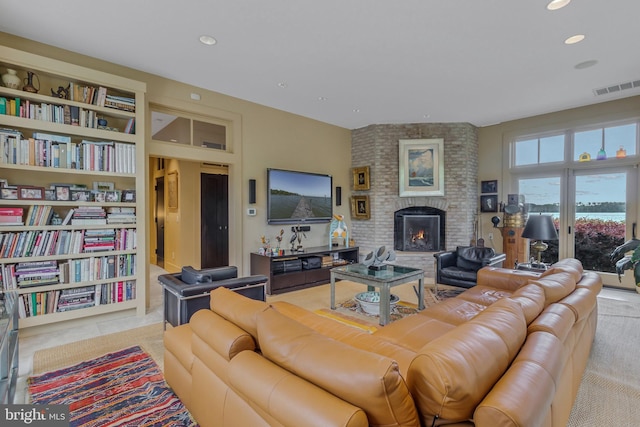 living room with built in shelves and a fireplace