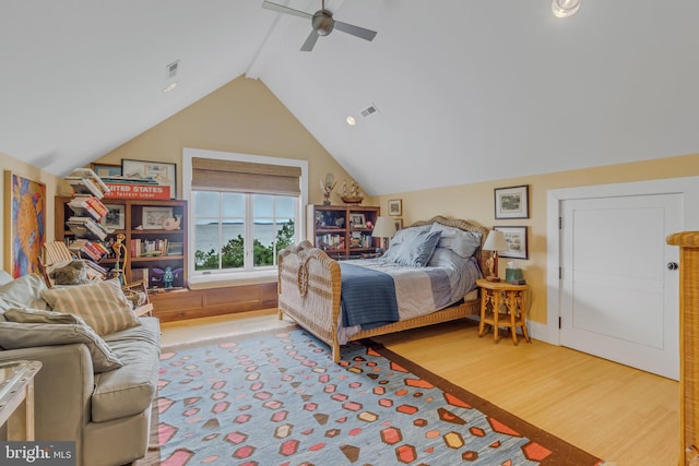 bedroom with hardwood / wood-style flooring, ceiling fan, and lofted ceiling with beams