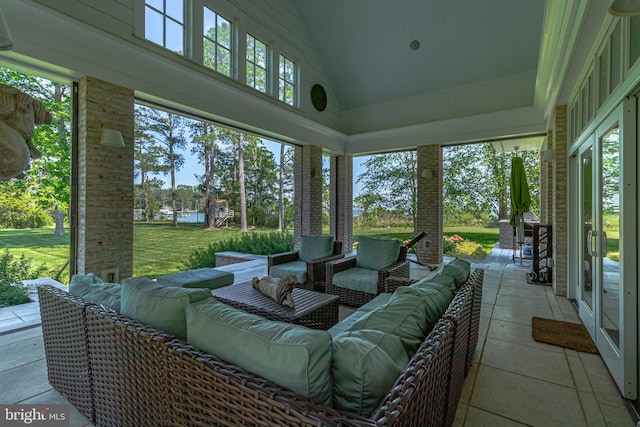 sunroom featuring vaulted ceiling