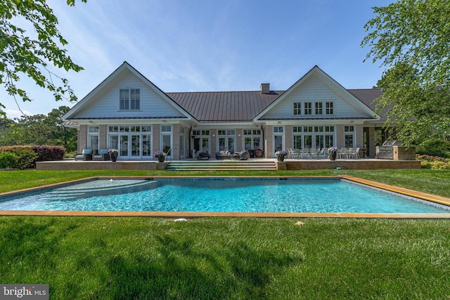 rear view of property with area for grilling, a patio area, a yard, and french doors