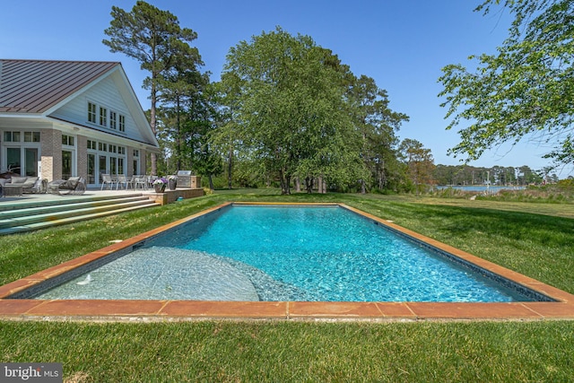 view of swimming pool with a yard and a patio area