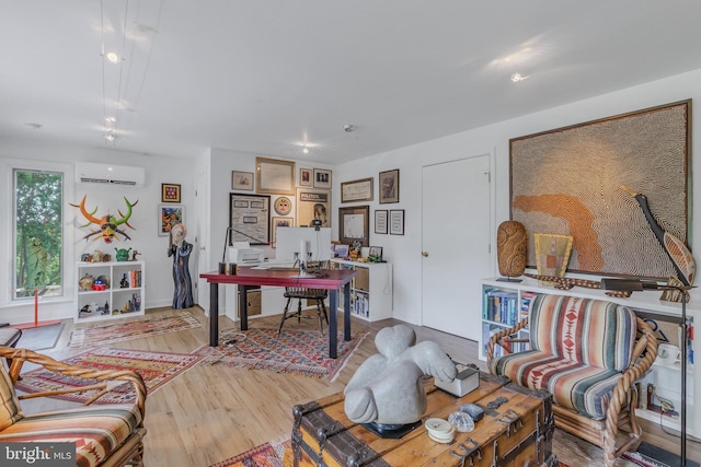 office space featuring an AC wall unit and light hardwood / wood-style floors