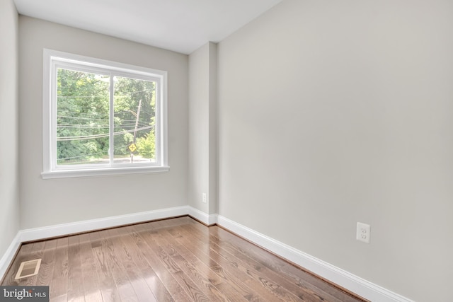 unfurnished room with light wood-type flooring