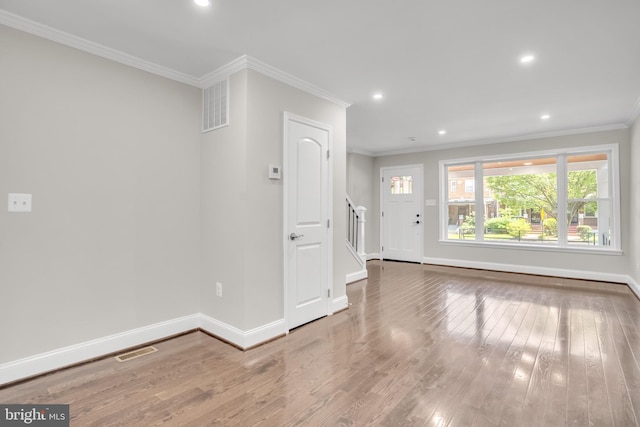 interior space featuring hardwood / wood-style floors and crown molding